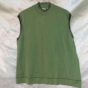 Light green sleeveless
turtleneck with small black accents.